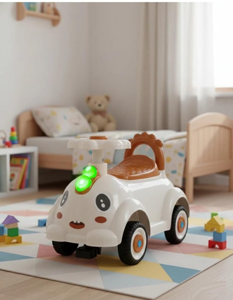 A white Funfizz ride-on car with a cartoon face and a green indicator light, on a play mat in a nursery